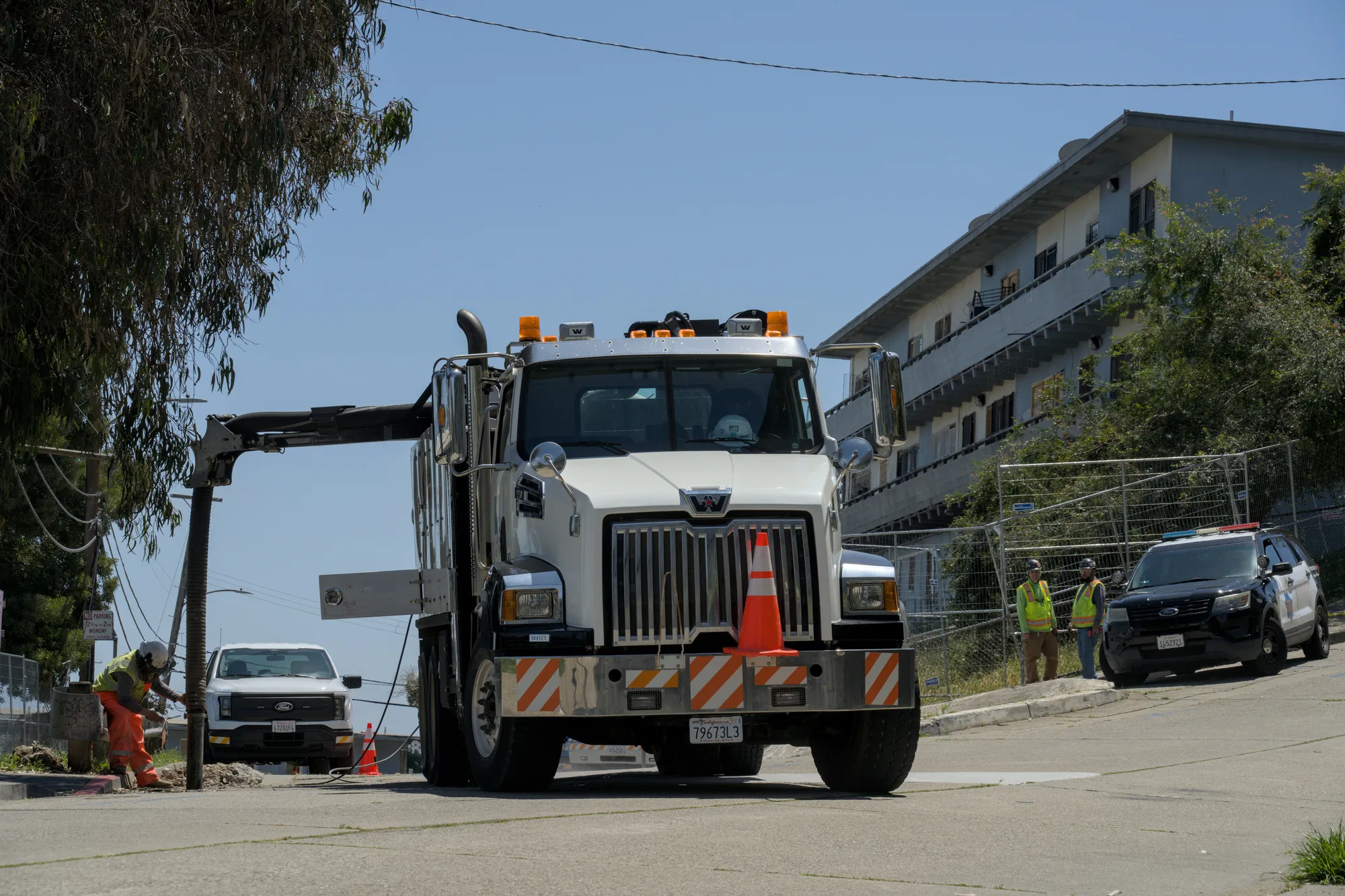 May 7th, 2026: An SFPD squad car sits idle while PG&E employees operate heavy machinery.