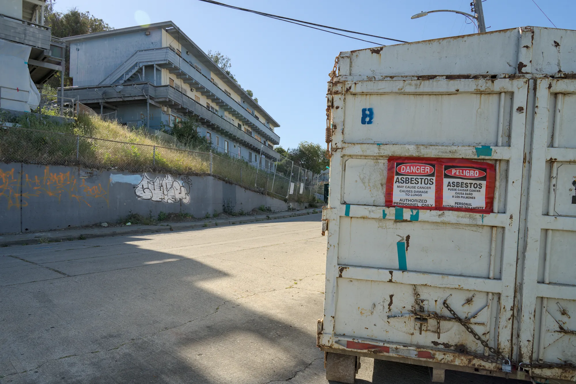May 20th, 2026: A dumpster sits in the Potrero Annex neighborhood with a 'DANGER ASBESTOS' warning sign.